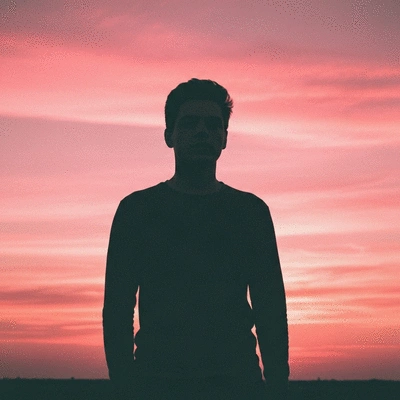 Parent feeding baby new food, soft lighting, warm colors